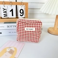 Detail of red gingham mini cosmetic bag with zipper and May Rabbit brand label - Red Check