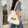 Borsa a tracolla in nylon crema con scritta Beach rossa e dettagli gialli - Beach Beige