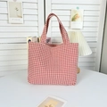 Detail of red gingham canvas tote bag handle and texture in a soft natural light setting - Small Red-Yellow Grid