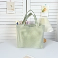 Detail of green plaid canvas tote bag with dual handles on a minimalist table set - Green Gingham