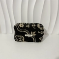 Detail of soft black sherpa makeup bag with white bohemian pattern and May Rabbit label - Ethnic Black Totem