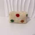 Close-up of the soft plush material and colorful polka dots on the makeup bag - Colored Polka Dots