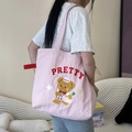 Close-up of pink canvas tote bag featuring an embroidered bear and PRETTY text detail - Pretty Bear (Pink)