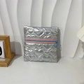 Detail of silver heart-quilted PU jewelry pouch with pink zipper and blue ring puller - Heart Silver