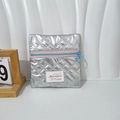 Close-up of metallic silver quilted pouch with pink zipper and light blue circular puller - Silver Rhombic Pattern