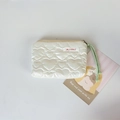 Detail of quilted heart texture on a cream PU leather mini makeup and coin pouch - Off-white Heart
