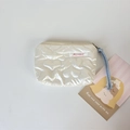 Close-up of quilted PU heart pattern coin purse with blue braided wrist strap and zip - Cream White Large Heart