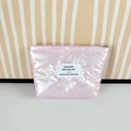 Close-up of pink quilted puffy cosmetic bag with bow embroidery and gold zipper - Small Bow Pink