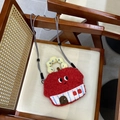 Detail of red plush creative house-shaped crossbody bag on a wooden vintage chair - Little House