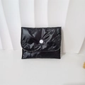Detail of black butterfly embossed PU coin purse with a soft quilted texture and button - Mini Bowknot Necklace / Black