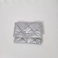 Macro shot of silver quilted pouch with classic diamond stitching and metal snap closure - Bubble Lattice / Silver
