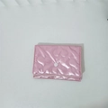 Detail of pink metallic heart quilted makeup bag with a white snap button closure - Large Heart / Pink