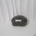 Close-up of soft grey plush makeup bag with a woven mayrabbit label and zipper - Gray