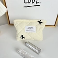 Detail of quilted cosmetic bag with cute rabbit embroidery and square woven label - Lipstick Bag Creamy White