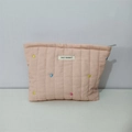 Close-up of quilted heart embroidery and branded label on pink cosmetic pouch - Pink Heart Embroidered Cosmetic Bag