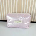 Detail of pink quilted makeup bag with bow patterns and metallic pearl finish - Small Bow Pink