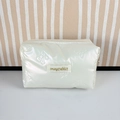 Close-up of pearl white PU quilted cosmetic bag with embossed bow patterns and zipper - Small Bowknot Cream White