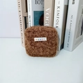 Close-up of a brown plush square storage bag with soft texture and logo detail - Maillard Brown