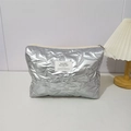 Detail of silver star quilted cosmetic bag with metal finish and zipper closure - Star Pattern Silver