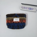 Close-up of plush geometric wave pattern cosmetic bag with soft lamb wool texture - Retro Figure