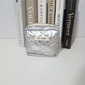 Detail of silver quilted PU cosmetic bag with metallic finish and brand label - Silver Rhombic Pattern