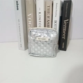 Detailed view of silver quilted makeup bag with MAY RABBIT tag and sleek zipper closure - Silver Small Grid