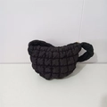 Detail shot of the black quilted cloud bag showing the soft texture and zipper closure - Black