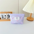 Close-up of a purple gingham makeup bag with pink bows and a zipper closure - Checkered Print Bow Purple