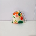Detail of floral printed cotton drawstring bag with orange flowers and white cords - Red and Green Floral