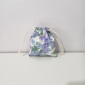 Detail of floral drawstring storage bag featuring blue and purple flower patterns - Violet