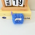 Detail of plush electric blue earphone case with fuzzy texture and woven logo tag - Blue