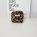 Detail view of leopard print plush organizer bag with a sewn logo on a white background - Brown Leopard Sherpa