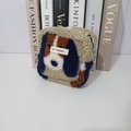 Detail of plush dog-shaped makeup bag with furry texture and MAY RABBIT brand label - Plush Dog