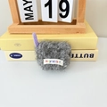 Detail of plush gray wireless earphone case with purple charm and mayrabbit logo - Gray
