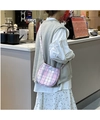 Close-up of pink checkered crossbody phone bag with blue button on female model - Pink Plaid (Shiny) Egg Bag