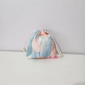 Close-up of small cotton drawstring bag featuring delicate tulip floral pattern print - Red Tulip