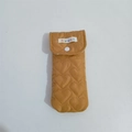 Detail of yellow heart-quilted glasses pouch with resin snap button and fabric label - Brown Heart