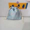 Detail of blue plaid drawstring pouch with pink bow prints on cotton fabric - Blue Plaid