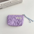 Detail of lavender heart-quilted pouch with May Rabbit label and light blue zipper pull - Purple