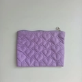 Macro detail of lavender quilted heart pattern on a large capacity storage pouch - Purple