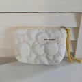 Detailed macro view of white quilted fabric coin purse with yellow woven lanyard and zipper - Quilted Flower