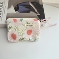 Detailed macro of floral cotton coin purse fabric with pink woven rope zipper pull - Pink Peony