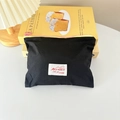 Detail of black portable makeup bag with vibrant pink zipper and a white woven label - Horizontal Style / Black