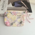 Close-up of floral cotton coin purse with MAY RABBIT label and pink rope zipper pull - Peony Pink