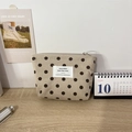 Detail view of beige corduroy polka dot handbag with texture and zipper on wood desk - Khaki Polka Dot Lipstick Bag