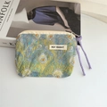 Detailed shot of canvas coin purse with peacock feather pattern and MAY RABBIT label - Phoenix Feather
