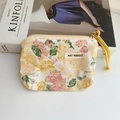 Detail of floral canvas coin purse with yellow rope handle and May Rabbit woven label - Peony Yellow