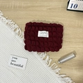Macro detail of wine red bubble texture canvas makeup bag with premium zipper and label - Bubble Wine Red