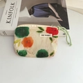 Close-up of small floral cotton coin purse with drawstring zipper on Kinfolk book - Red and Green Floral