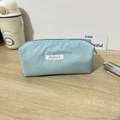 Macro detail of the Mayrabbit light blue nylon storage bag showing fabric texture and logo - 19x6x7cm / Blue